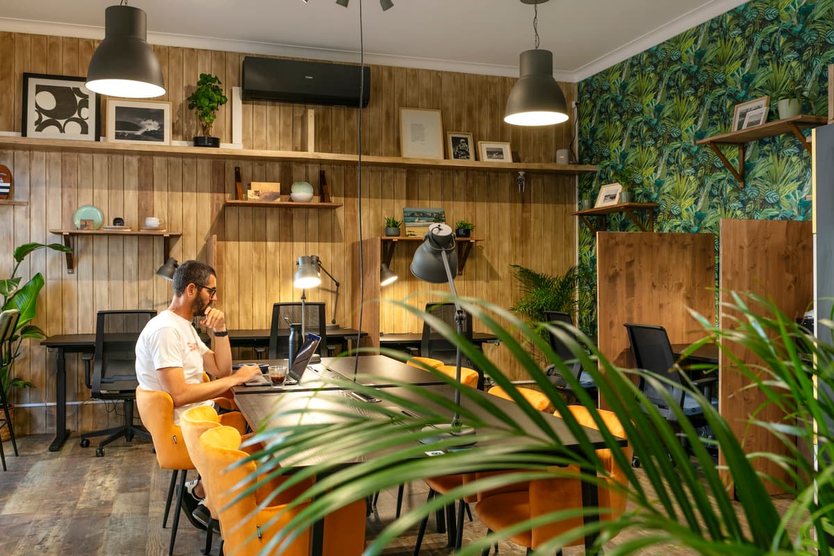Modern coworking space with bright orange chairs.