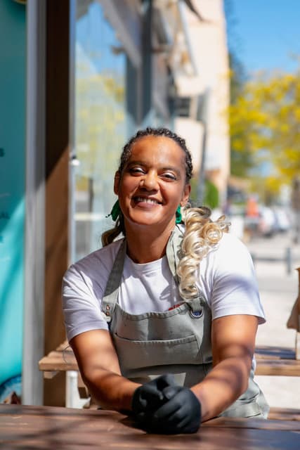 Staff member for poke smiling to the camera.