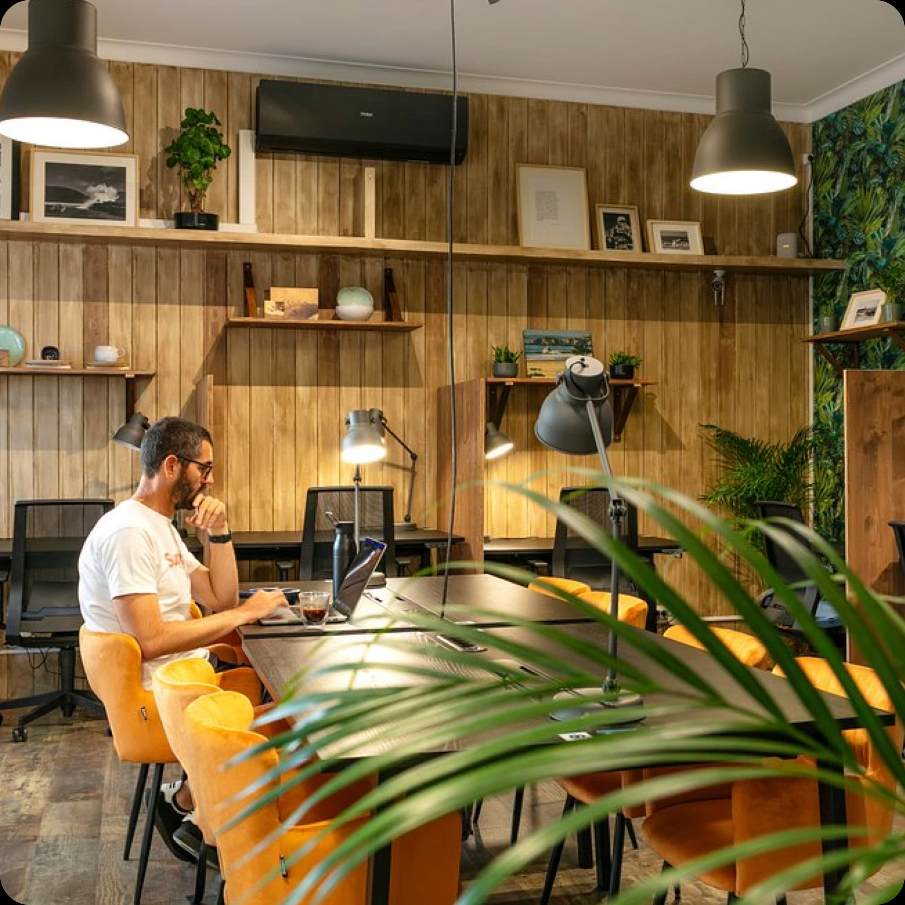 A man working on his laptop in the stylish and quiet coworking space at Rocha Beach House.