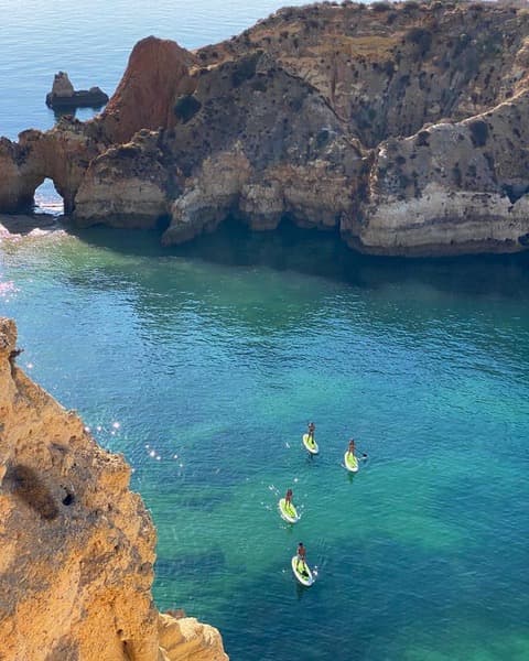 Top view of a SUP tour with four puddle boards. You can see crystal clear waters and a hidden cave.